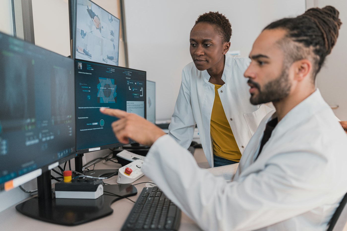 Two clinicians discussing results on a screen